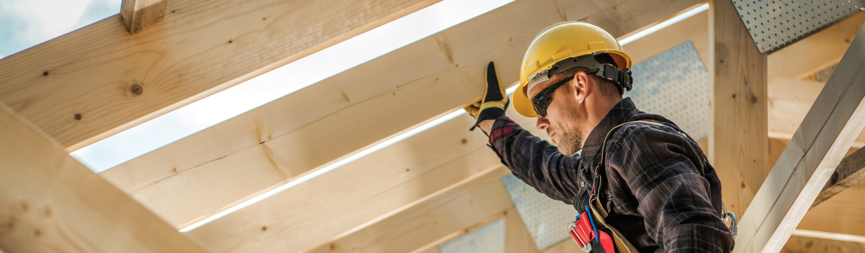 Handyman wearing hard hat fixing rafters of roof needs Tax Relief USA